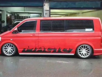 Fire red Volkswagen Multivan aimgain MPV low lying wind